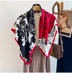 Detail of vintage floral pattern silk-like scarf draped over an outfit with accessory