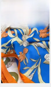 Close-up of premium royal blue floral silk scarf showing delicate rolled edge craftsmanship