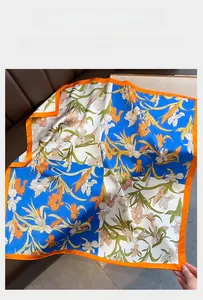 Detail of silk-satin scarf featuring vintage iris floral patterns and orange borders