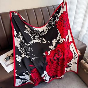 Silk-like square scarf featuring bold red rose print on black and white background