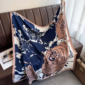 Close-up of vintage floral silk scarf featuring elegant rose patterns and smooth texture