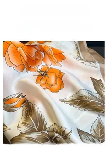 Detailed view of floral satin scarf texture with orange rose patterns and silky sheen