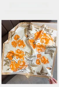 Detail showing elegant orange rose floral print on silky 70cm square scarf with gold border