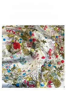 Detail of floral printed satin scarf with high-gloss texture and vibrant flower patterns