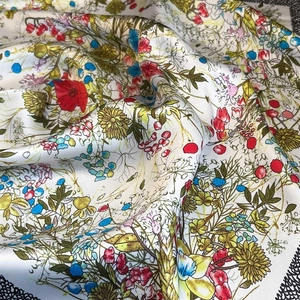 Macro shot of floral printed silk scarf showing fine texture and vivid floral patterns