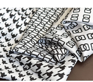 Detail of classic houndstooth and geometric chain pattern on soft twill silk scarf