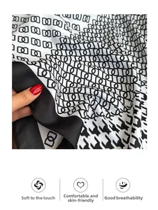 Detail of soft houndstooth silk scarf showing premium breathable fabric texture
