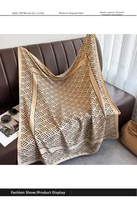 Detail showing a 90x90cm gold and black geometric patterned polyester silk scarf