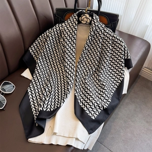 Detail of classic black and white square silk scarf with geometric V-letter pattern print