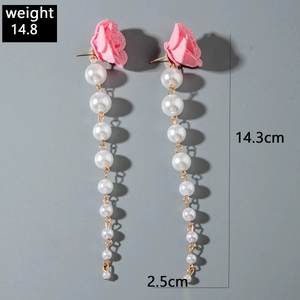 Detail of pink fabric flower earrings with white pearls and length measurement labels