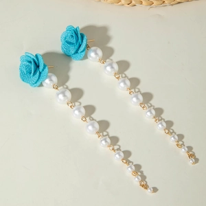 Detail of tulip fabric earrings with light blue roses and dangling white pearl tassels