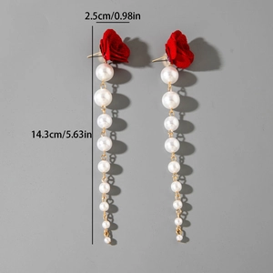Detail view showing tulip flower earrings with long pearl tassels and 14.3cm length measurement