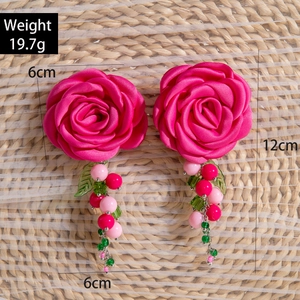 Detail of rose floral earrings with satin petals and tassel beads shown with dimensions
