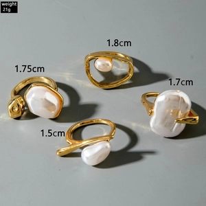 Detailed view of four golden irregular liquid metal rings with baroque pearls and sizing