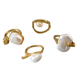 Set of four gold geometric rings with baroque pearls in a French retro minimalist style