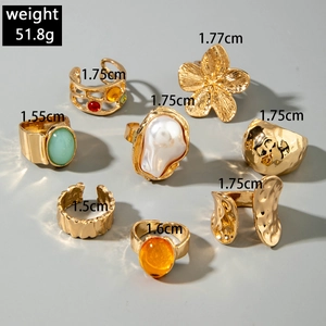 8-piece gold wide ring set with floral designs, colorful gemstones and pearls