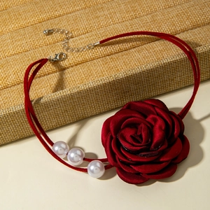 Detail view of red silk rose choker featuring triple pearls and elegant double-cord design