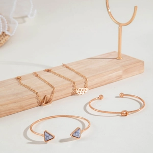 Rose gold jewelry set with marble triangle open bracelet and geometric pendants