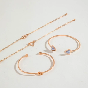 Rose gold 4-piece bracelet set featuring marble triangle stone and geometric charms
