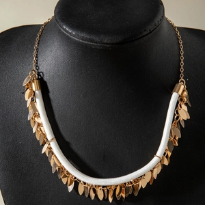 Bohemian gold leaf fringe necklace with white braided rope displayed on neck mannequin