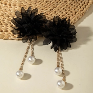 Detail of black organza flower earrings with rhinestone tassels and white pearls
