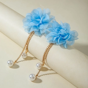 Detail of light blue mesh flower earrings with gold tassel chains and faux pearls