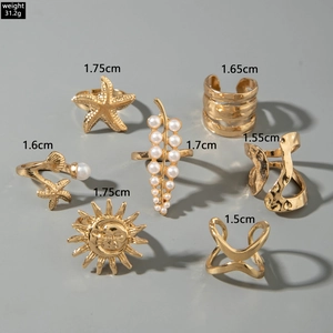 Detailed view of 7-piece bohemian gold alloy ring set with starfish and sun motifs