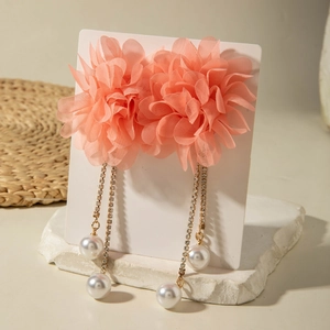 Detail of pink chiffon flower earrings with long gold diamond chains and pearls