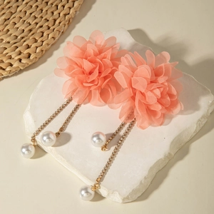 Detail of pink fabric flower earrings with sparkling rhinestone tassels and faux pearls