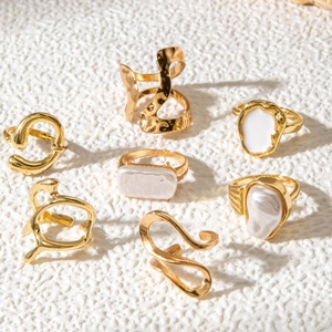 Set of gold geometric rings featuring baroque pearls and hammer-textured organic designs