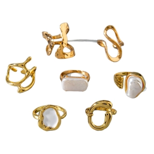 Minimalist gold geometric jewelry set featuring baroque pearl rings and irregular ear cuffs