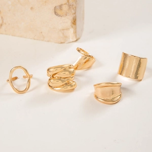 4-piece set of minimalist gold geometric rings with irregular and wavy metallic designs