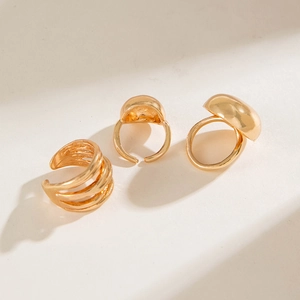 Polished gold geometric ring set with multi-layer lines and smooth domed surface details