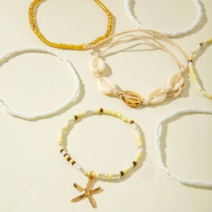 Detail view of 6-piece Bohemian beach bracelet set with starfish and natural shell charms