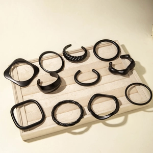 Set of 11 matte black geometric acrylic bangles and bracelets in minimalist designs