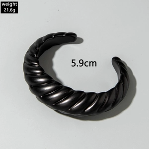 Close-up of black acrylic twisted bangle, 5.9cm diameter and 21.6g weight detail