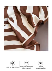 Detailed macro view showing the soft, breathable texture of the zebra print silk scarf