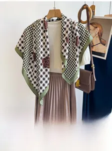 Detail view of premium twill silk scarf with green plaid and vintage floral pattern