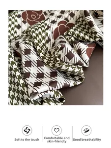 Macro detail showing soft, breathable fabric with houndstooth and floral patterns