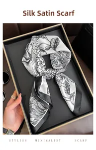 Close-up of elegant black and white floral silk scarf displayed on a stylish vanity