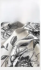 Macro detail of silk scarf showing floral print and premium hand-stitched rolled edges