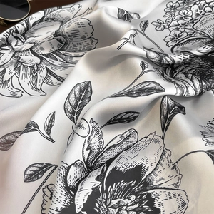 Vintage black and white floral silk scarf with elegant drape and pearl-like glossy finish