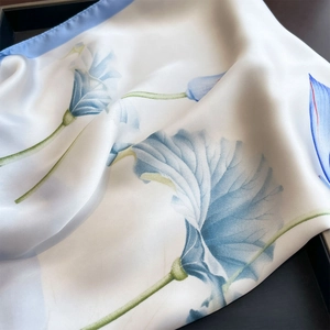Elegant white silk square scarf featuring delicate blue lotus print and satin finish