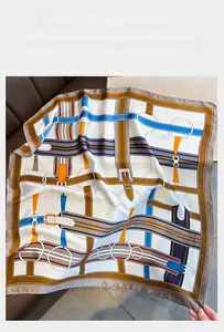Detail of luxury silk square scarf featuring vintage horse bridle and leather belt prints