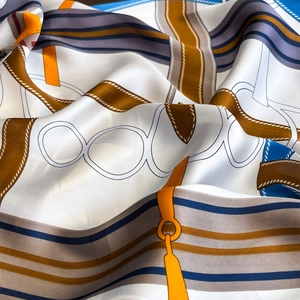 Silk square scarf with luxury belt and chain print featuring elegant blue and orange accents