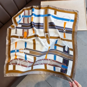 Elegant square silk scarf featuring luxury belt and buckle print in blue and brown tones