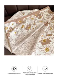 Detail of floral printed silk scarf with smooth twill texture and soft beige fabric