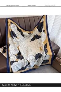 Polyester 90x90cm vintage square scarf with rose print displayed on a leather sofa