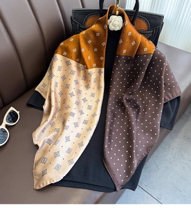 Detailed shot of retro patterned silk scarf with polka dots and geometric textures