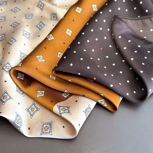 Three elegant silk square scarves with diamond and polka dot patterns for professional wear